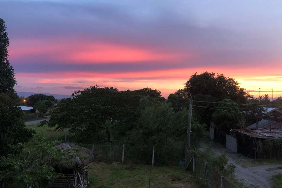 An image of Jenny meditating on her yoga mat at sunrise. Photo taken by Jenny Blancaflor