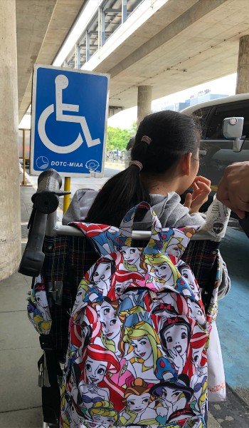 miss a travels waiting on queue for taxi outside airport