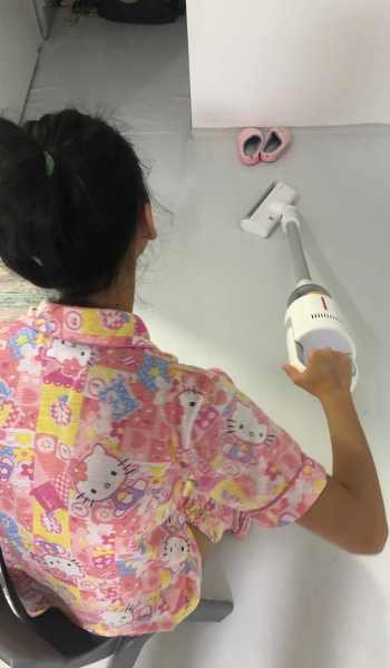 miss a using a vacuum to clean her bedroom